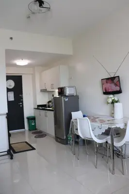 a kitchen with a table and chairs and a refrigerator at Luxury Condo-Princeton Residence-New Manila Quezon City-Fast Wi-fi150mbps in Manila