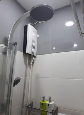 a bathroom with a shower and a mirror at Luxury Condo-Princeton Residence-New Manila Quezon City-Fast Wi-fi150mbps in Manila