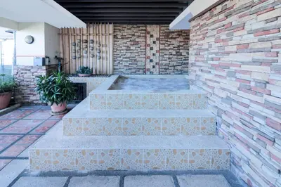 a set of three concrete steps with a brick wall at Greenhills Elan Hotel Modern - Newly Renovated in Manila