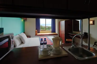 a kitchen with a sink and a kitchen with a room at Microtel by Wyndham Eagle Ridge in General Trias