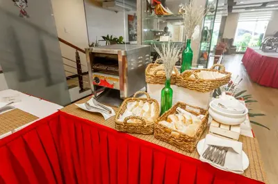 a table with baskets of food on a table with a counter sidx sidx at Microtel by Wyndham Mall of Asia in Manila