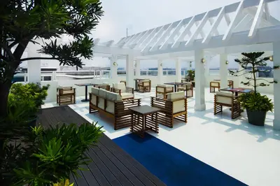 a pavilion with tables and chairs on a patio at Microtel by Wyndham Mall of Asia in Manila