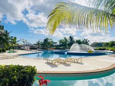 a swimming pool with a fountain in the middle at Aquamira Hotel & Resort in Tanza