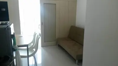 a living room with a couch and a chair at Light Residences 1BR Apartment Balcony in Manila