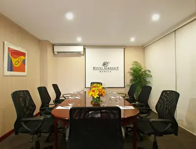 a conference room with a long table and chairs at Hotel Kimberly Manila in Manila