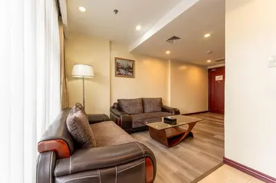 a living room with a couch and a table at Swiss-Belhotel Blulane in Manila