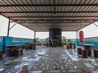 a patio with tables and benches on a building at Alicia Apartment in Manila