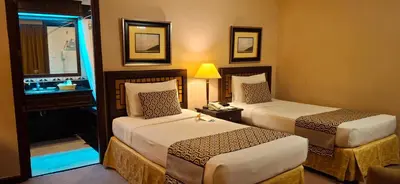 a hotel room with two beds and a window at Herald Suites Solana in Manila