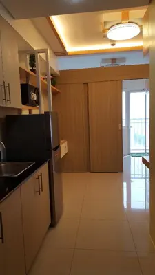 a kitchen with a sink and a refrigerator at Breeze Residences by CS Luxe in Manila