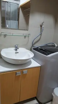a bathroom with a sink and a toilet at Breeze Residences by CS Luxe in Manila