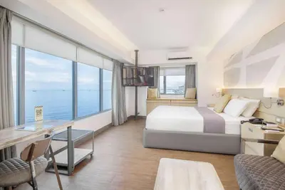 a hotel room with a bed and a large window at TRYP by Wyndham Mall of Asia Manila in Manila
