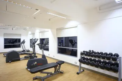 a gym with treadmills and exercise bikes in a room at TRYP by Wyndham Mall of Asia Manila in Manila