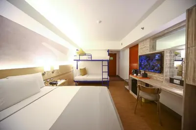 a hotel room with a bed and a tv at TRYP by Wyndham Mall of Asia Manila in Manila