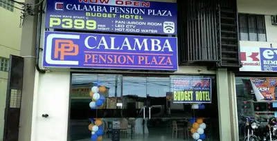 a store with signs on the side of a building at Calamba Pension Plaza in Calamba