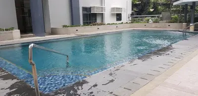 a swimming pool with blue water in a building at 5E Tower 2 Viceroy in Manila
