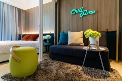 a hotel room with a couch and a bed at Azure Urban Beach Resort Manila by Radlett in Manila