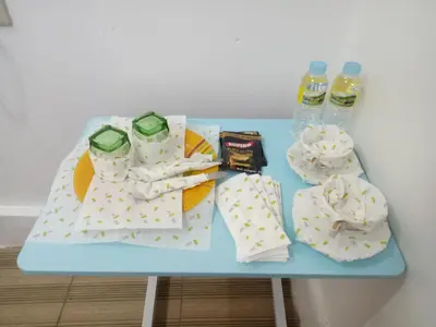 a blue table with snacks and water bottles on it at MJ Home in Manila