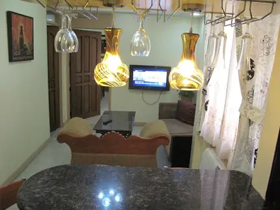 a dining room with a table and some lights at Makati Suites at Travelers Inn in Manila