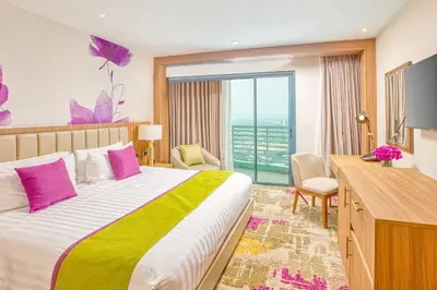 a hotel room with a bed and a large window at Eastwood Richmonde Hotel Quezon City in Manila