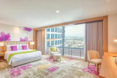 a hotel room with a bed and a large window at Eastwood Richmonde Hotel Quezon City in Manila