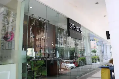 a store with a sign on the side of a building at One Palm Tree Villas MANILA in Manila