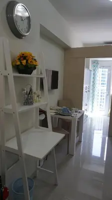 a room with a shelf and a clock on the wall at Jazz Hunter Residence in Manila