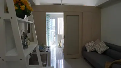 a living room with a couch and a sliding door at Jazz Hunter Residence in Manila