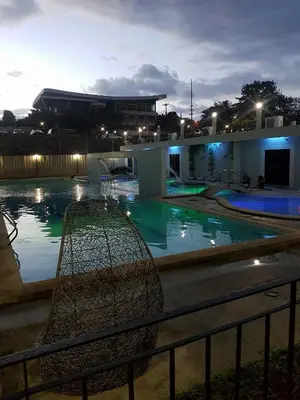 a swimming pool at night with the lights on at Centropolis in Manila