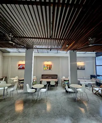 a group of tables and chairs in a room at Monchere Dormitory in Manila