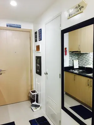 a kitchen with a door leading into a kitchen with a sink at SMDC Light Residences Condominium in Manila