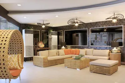 a living room with two couches and a table at Rothman Hotel in Manila