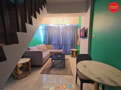a living room with a couch and a table at Skyloft Hotel in Manila