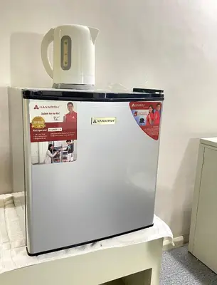 a refrigerator with a jug on top of it at Riverview Resort and Conference Center in Calamba