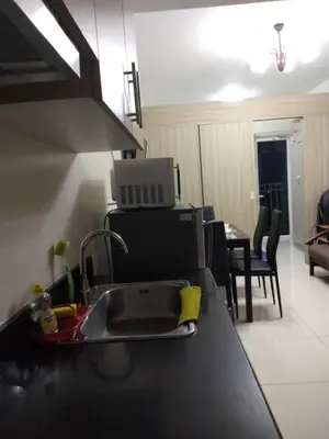 a kitchen with a sink and a counter top at SMDC Breeze Residences by Dominga in Manila