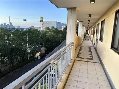 a balcony of a building with a view of a city at East Ortigas Mansions by MA in Manila