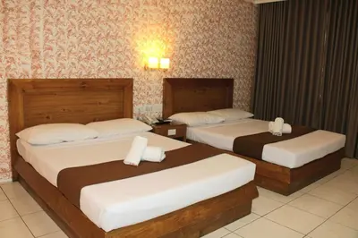 two beds in a hotel room with two beds at Rosas Garden Hotel in Manila