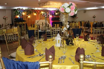 a table set up for a wedding with a yellow table cloth at Rosas Garden Hotel in Manila