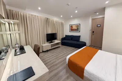 a hotel room with a bed and a couch at City Garden Hotel Makati in Manila