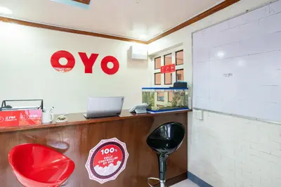 a xo restaurant with red chairs and a counter at Conrado's Apartelle in Manila