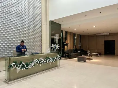 a man standing at a desk in a lobby at JR Studio Luxe 1824 at Princeton Residences in Manila