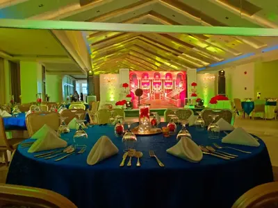 a dining room with a blue table with napkins and utensils at Hotel Marciano in Calamba