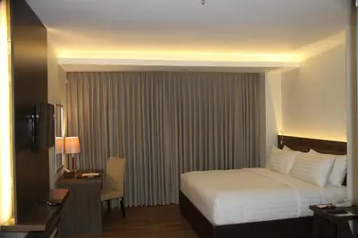 a hotel room with a bed and a desk and a bed sidx sidx sidx sidx at Hotel Marciano in Calamba
