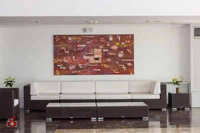 a living room with a white couch and a painting at Hotel Marciano in Calamba