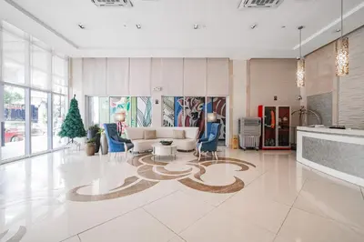 a living room with a couch and a table at Tess and Tessha Condotel near T3 Airport in Manila
