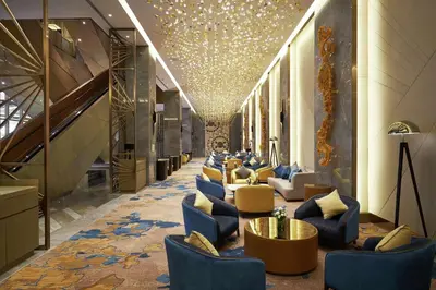 a lobby with a row of chairs and tables at Hilton Manila Newport World Resorts in Manila