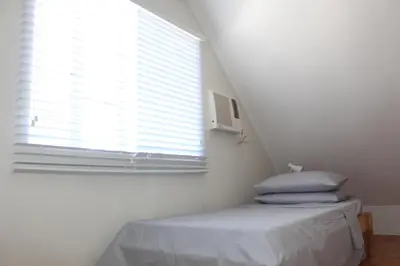 a white room with a bed and a window at # 15 Laguna Bel-Air Home in Sta Rosa by Red Door House Rental in Santa Rosa