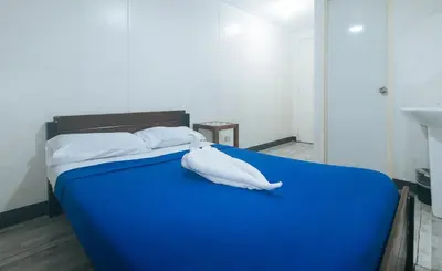 a blue bed with a stuffed animal on it at Metro Deluxe Residences near World Trade Center in Manila