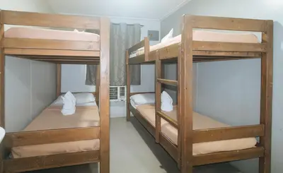 a room with three bunk beds in a room at Metro Deluxe Residences near World Trade Center in Manila