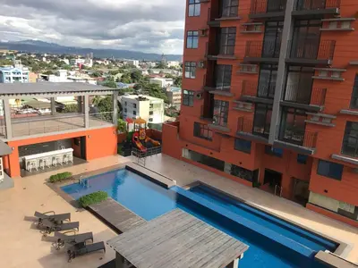 a swimming pool on the side of a building at Portovita Towers in Manila
