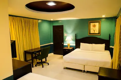 a bedroom with a bed and a desk with a desk at Dreamwave Resort Pansol Laguna in Calamba